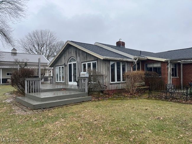 Rear view of property looking @ newer sun room addition & deck | Image 6