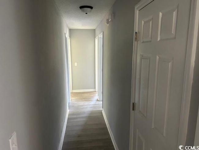 Hall featuring dark wood-style flooring and baseboards | Image 22