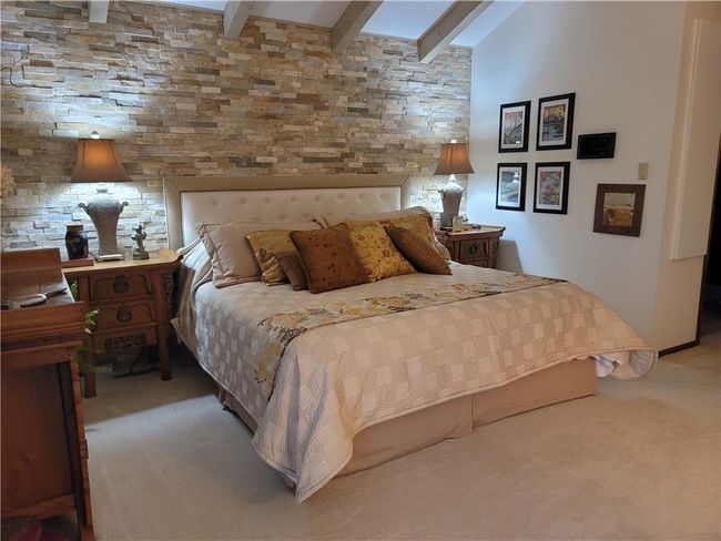 Bedroom with beam ceiling and carpet | Image 26
