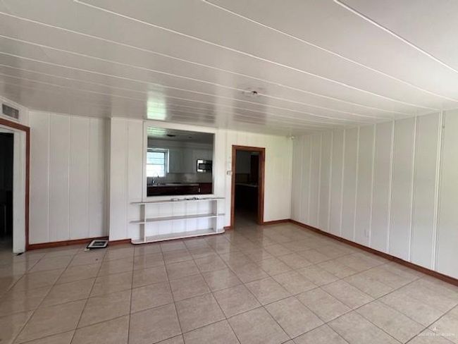 Unfurnished living room with baseboards and light tile patterned flooring | Image 4