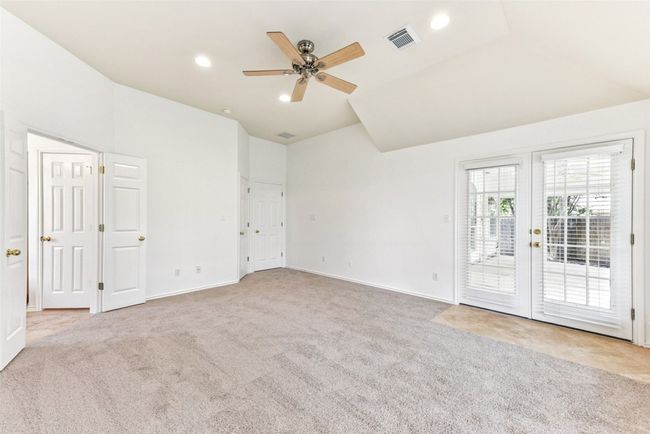 Primary bedroom with French doors to your covered back patio | Image 28