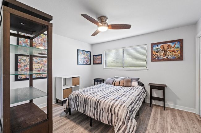 Bedroom with baseboards, a ceiling fan, and wood finished floors | Image 20