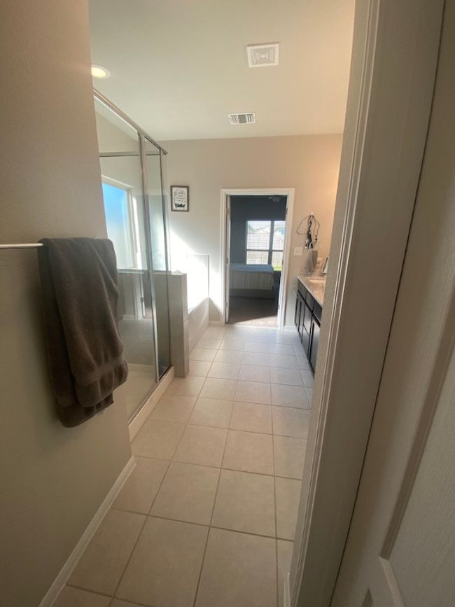Bathroom with baseboards, a stall shower, tile patterned floors, visible vents, and a garden tub | Image 19