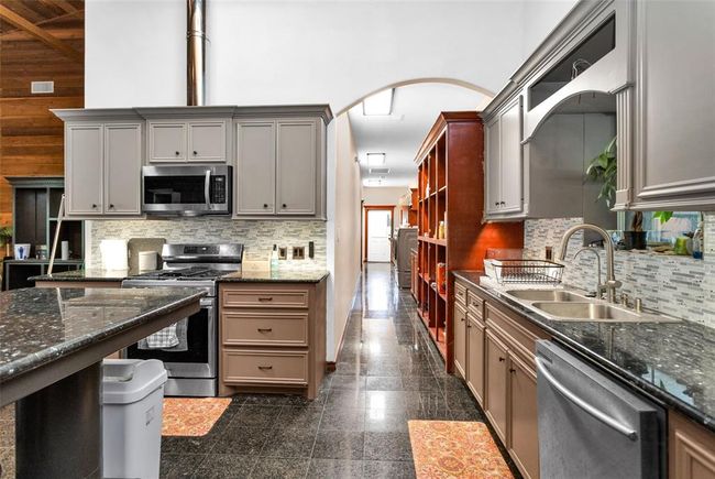 This hall has the pantry, laundry room, additional cabinets and door to the covered porch/car port. | Image 19