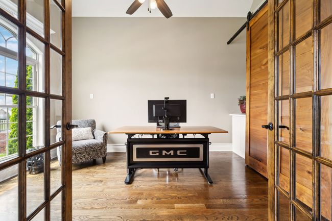First floor Office - Glass and wood frame french doors. Built in storage behind sliding wood doors. | Image 33
