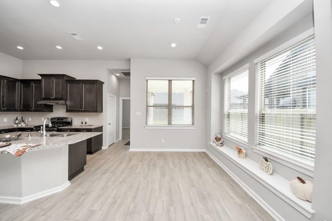 Bright dining space with views to the side on backyard | Image 13
