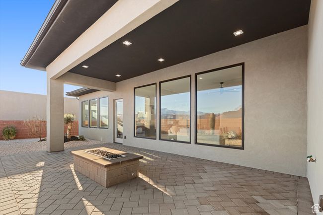 View of patio featuring an outdoor fire pit and fence | Image 29