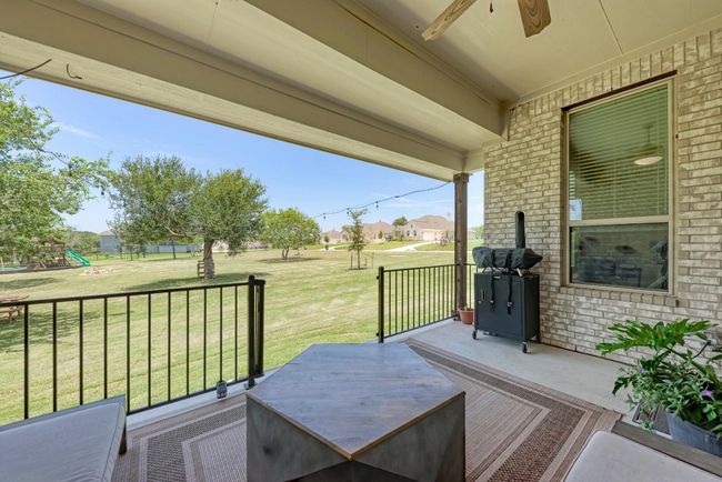 The back patio was extended by the builder and considered an upgrade. Enjoy relaxing or entertaining while viewing the pretty treed backyard. | Image 18
