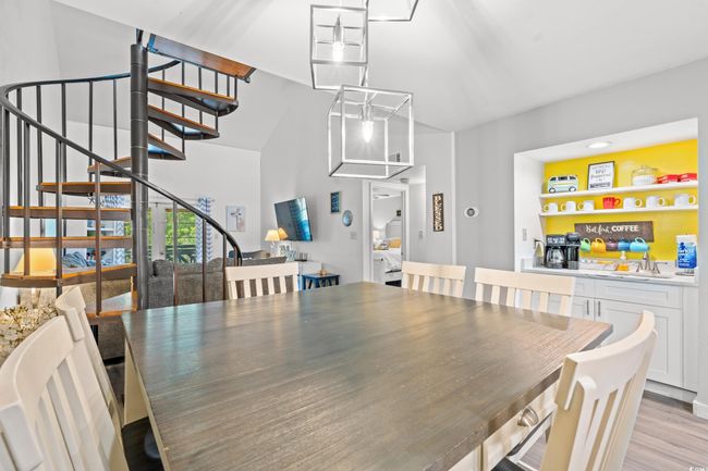 Dining room with stairway and light wood-style flooring | Image 10