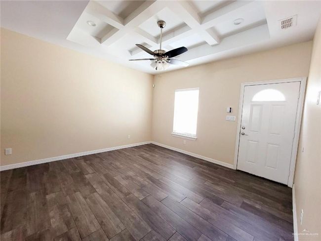 Foyer featuring coffered ceiling, dark wood-type flooring, a ceiling fan, and beam ceiling | Image 11