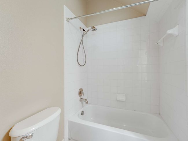 Bathroom featuring toilet and shower / tub combination | Image 21