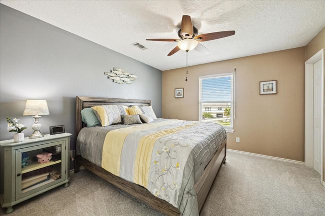 This inviting first-floor spare bedroom features a king-size bed, spacious walk-in closet, and a large nightstand, offering both comfort and convenience. | Image 20