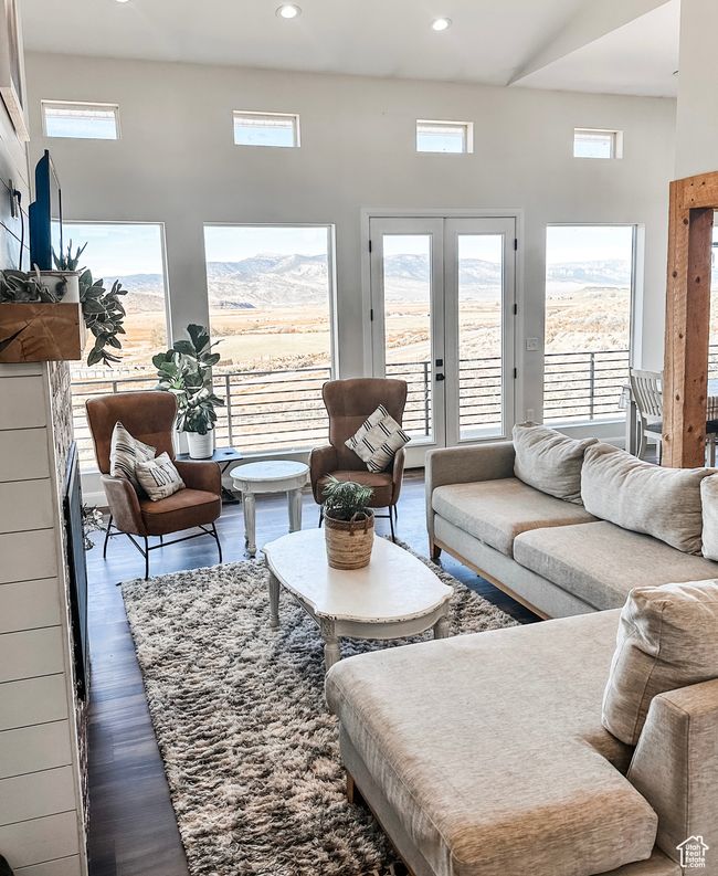 Living room featuring french doors, dark wood-style flooring, a mountain view, and recessed lighting | Image 6