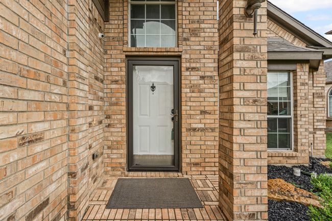 View of exterior entry with brick siding | Image 6