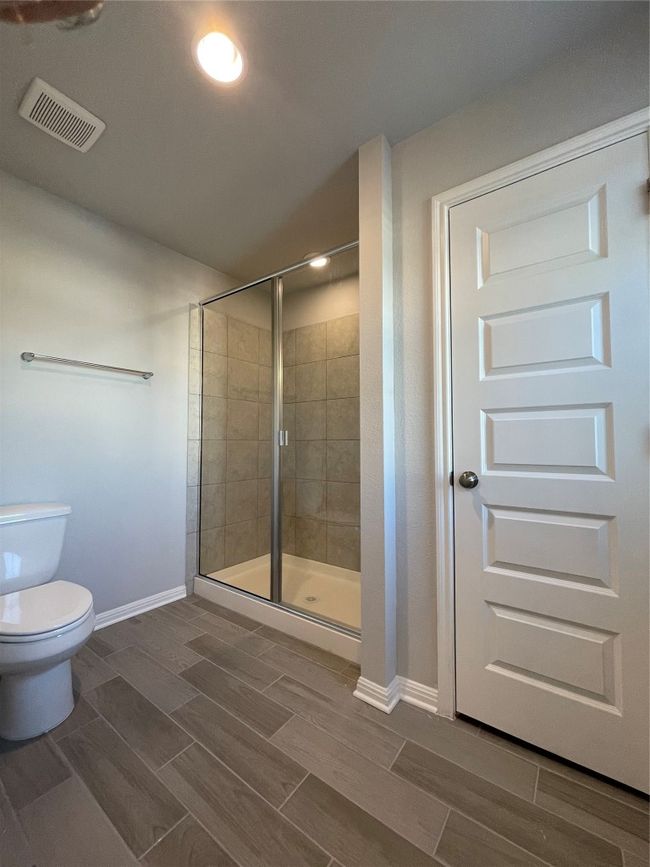 Full bath featuring a stall shower and wood tiled floors | Image 16