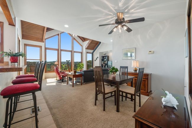Dining space featuring vaulted ceiling, ceiling fan, and recessed lighting | Image 10