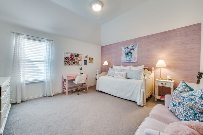 Bedroom with baseboards, ceiling fan, vaulted ceiling, and light carpet | Image 30