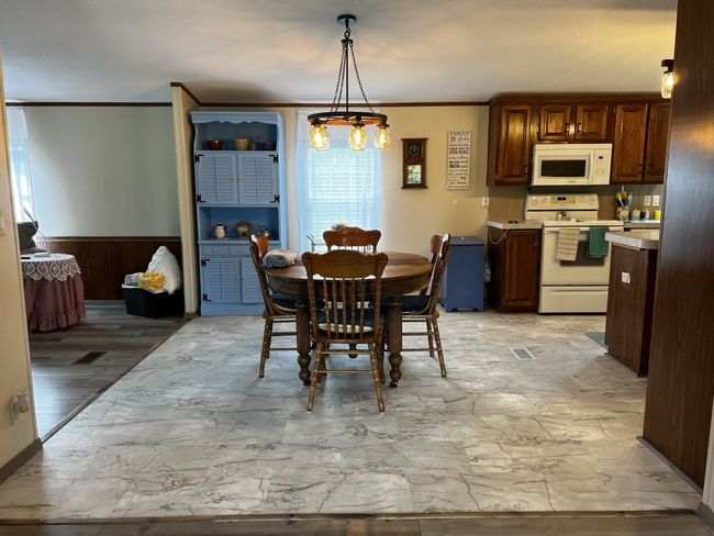 Dining room with new vinyl flooring. Perfect for family time! | Image 8
