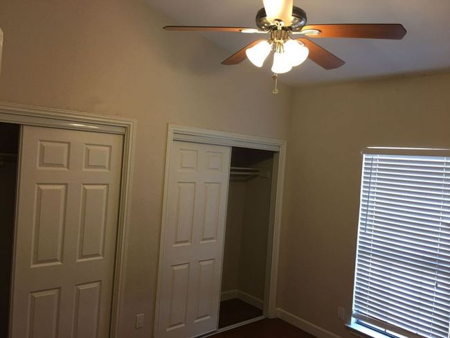 Unfurnished bedroom with a ceiling fan | Image 13