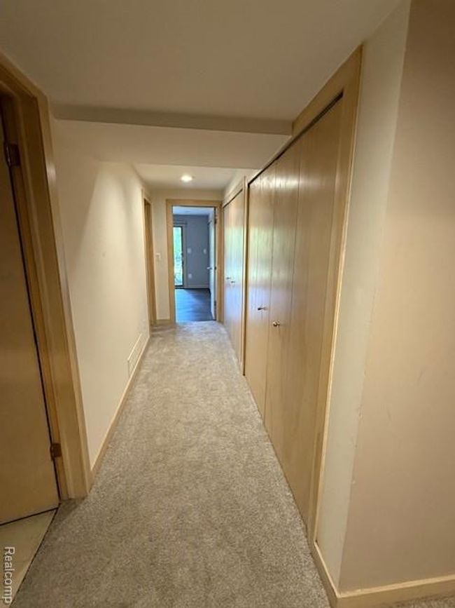 Hall featuring light colored carpet and baseboards | Image 14