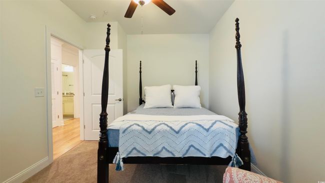 Bedroom with light carpet and ceiling fan | Image 9