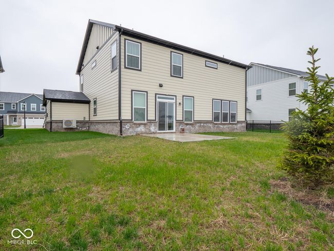 rear view of property with a patio area, board and batten siding, fence, and a lawn | Image 52