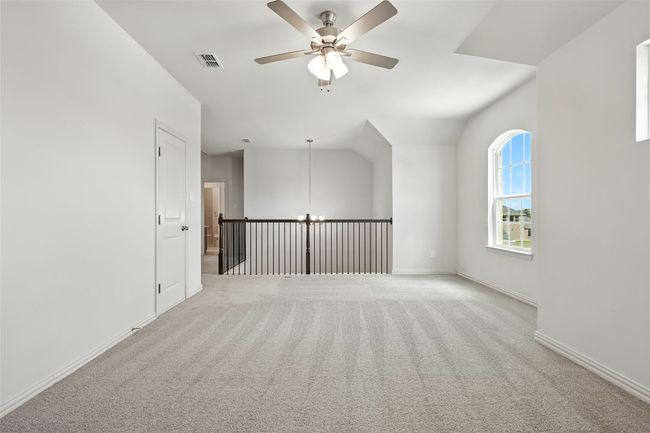 Spare room with a ceiling fan and light carpet | Image 29