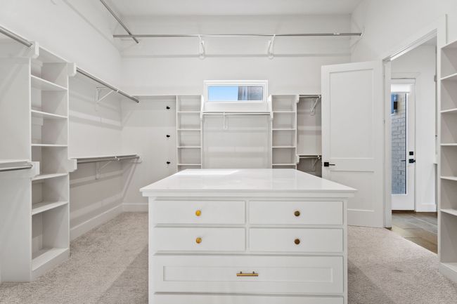 Spacious closet with light carpet | Image 19