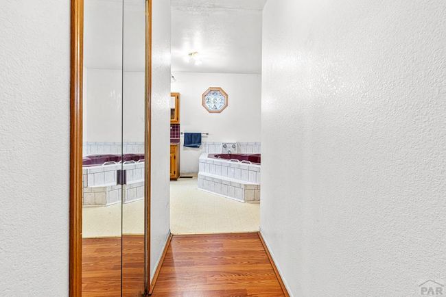 hallway to primary 5 piece bath and walk in close | Image 15