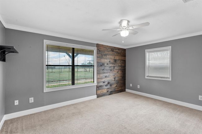 Unfurnished room featuring ceiling fan, plenty of natural light, crown molding, and carpet floors | Image 19