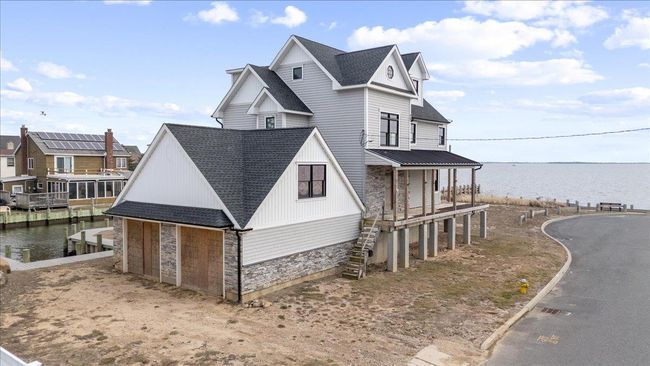 View of side of home with a porch and a water view | Image 11