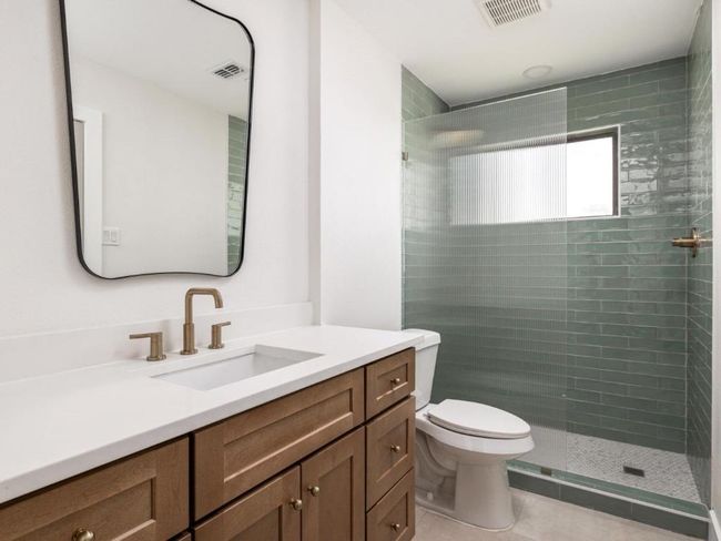 Full bath with vanity, visible vents, tiled shower, tile patterned flooring, and toilet | Image 6