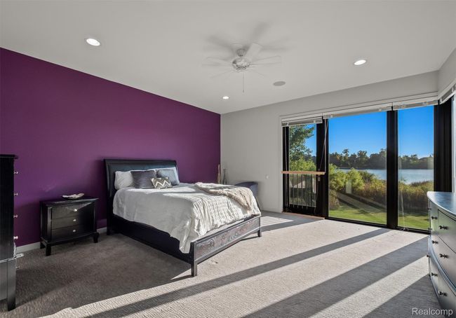 Carpeted bedroom with a water view, access to exterior, ceiling fan, and recessed lighting | Image 53
