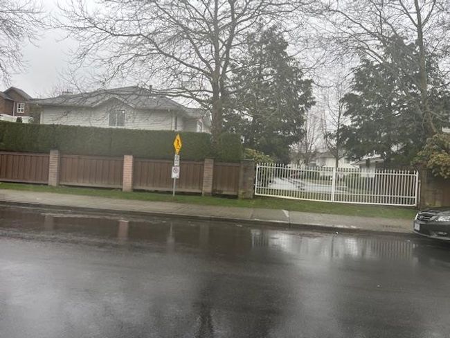 View of road featuring sidewalks and traffic signs | Image 7