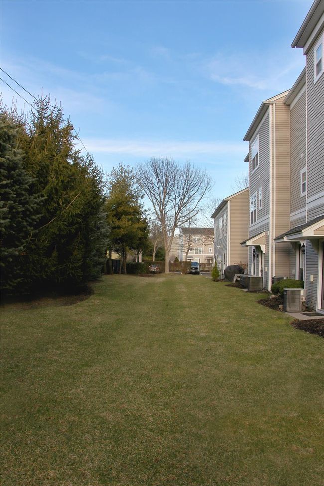 View of yard with cooling unit and a residential view | Image 27