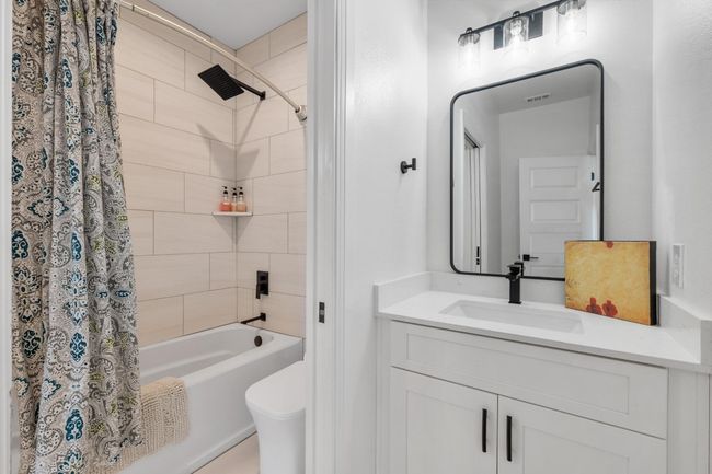 The secondary bedrooms are thoughtfully designed with a Jack-and-Jill bathroom, offering convenience, privacy, and stylish functionality. | Image 27