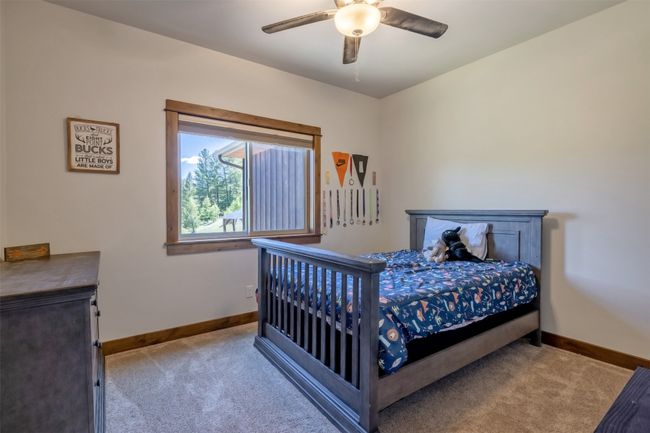 Bedroom with carpet floors, baseboards, and a ceiling fan | Image 23