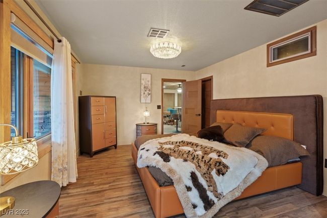 Bedroom with visible vents and wood finished floors | Image 47