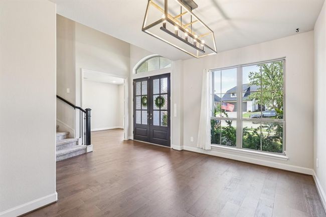 Second view of formal dining room leading to entry | Image 6