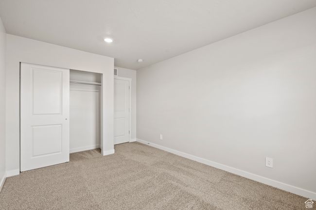 Unfurnished bedroom featuring light carpet, baseboards, a closet, and recessed lighting | Image 38