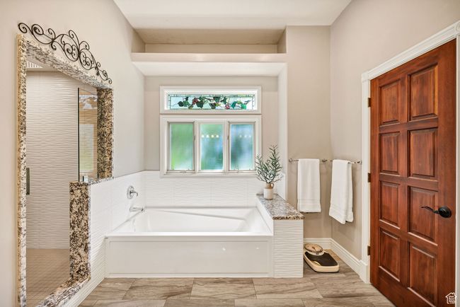 Bathroom with a bath and a shower stall | Image 37