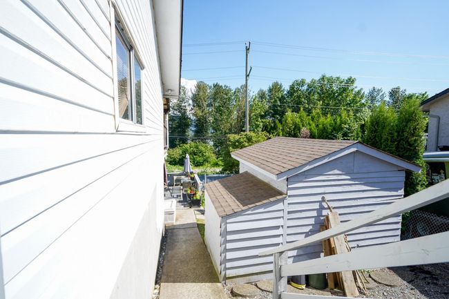 View of property exterior featuring roof with shingles | Image 18