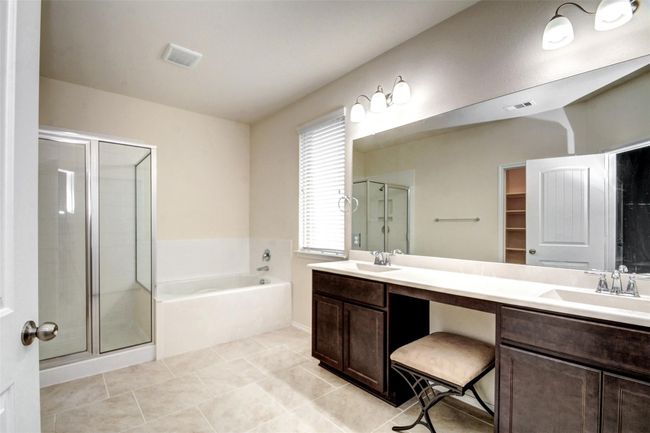 You will love this gorgeous bath complete with dual sinks and a large walk-in closet. | Image 19