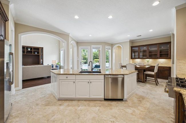 Massive kitchen tons of cabinet space with breakfast area and gorgeous views of the backyard, perfect for entertaining! | Image 18