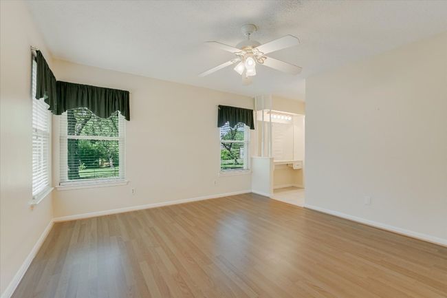 Empty room featuring light wood finished floors, baseboards, and a ceiling fan | Image 10