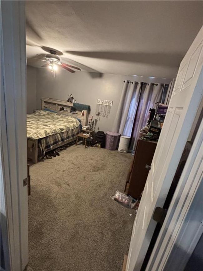 Bedroom featuring carpet and ceiling fan | Image 36