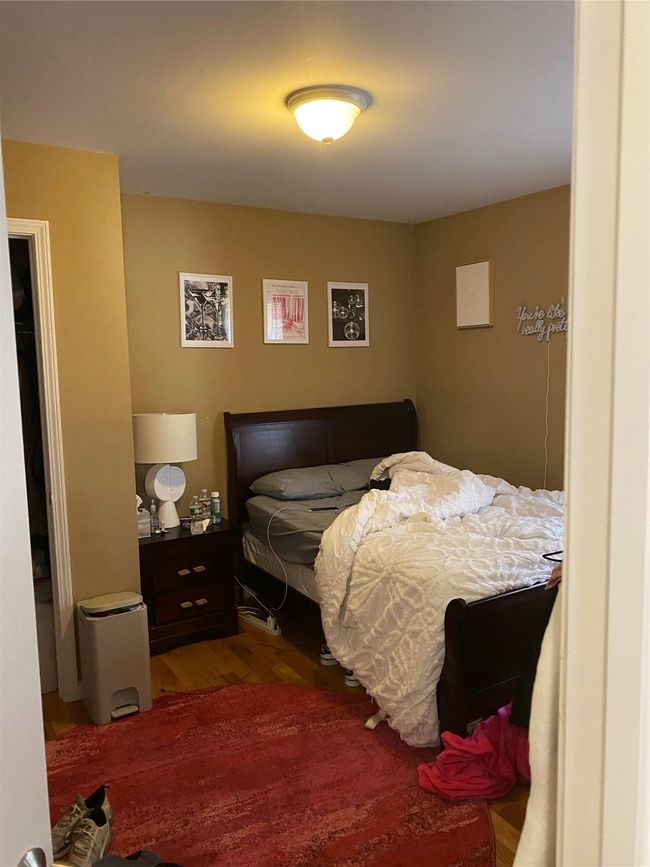 Bedroom with wood finished floors | Image 16