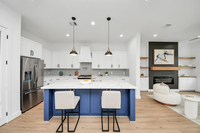The kitchen, an integral part of thishome's open-concept design, seamlessly flows off the living room, creating a harmonious andconnected living space. | Image 7