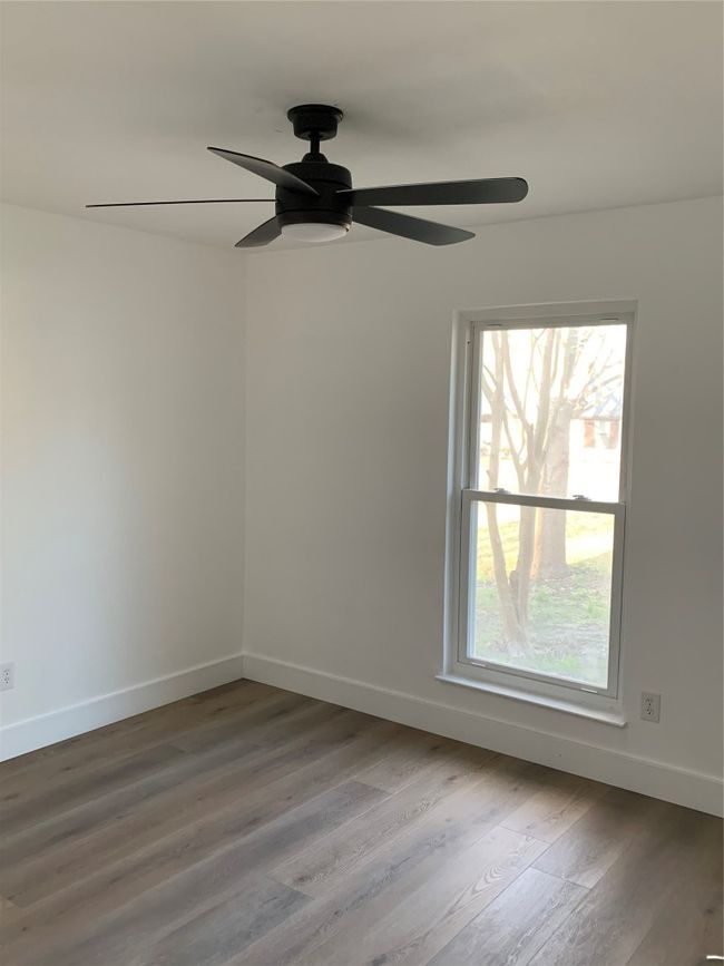 Spare room featuring ceiling fan and wood finished floors | Image 20