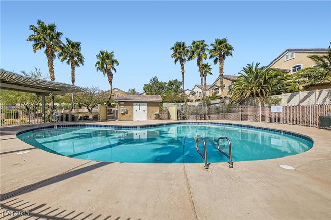 View of High Noon at Elkhorn community pool area featuring beautiful pergola covered area for shade, community clubhouse and safely fenced-in/enclosed deck areas surrounding the well maintained pool | Image 22
